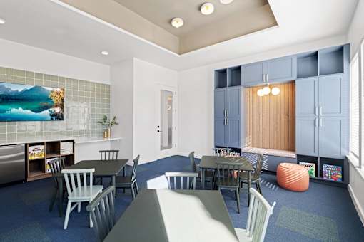a room with tables and chairs and a tv