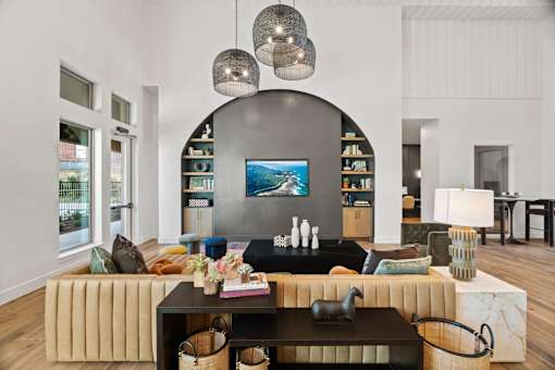 Resident lounge featuring comfortable seating, contemporary design finishes, and adjacent gathering space for socializing and relaxation.