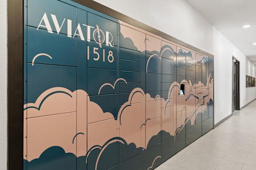 Package concierge locker system at Aviator 1518 apartments with custom branding.