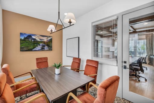 a room with a table and chairs and a window