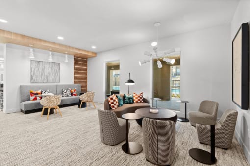 a room with a couch and chairs and a table