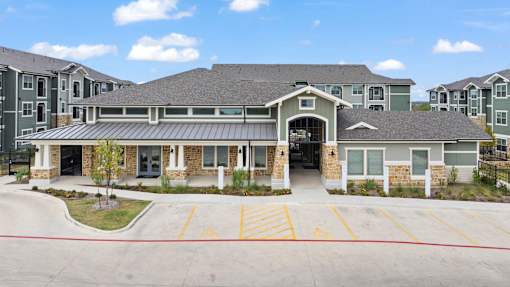 A large building with a parking lot in front of it.