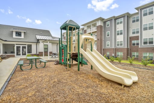 our apartments have a playground with a slide and picnic table
