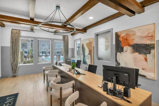a room with a desk and chairs