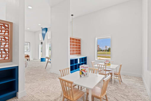 a room with tables and chairs and a window
