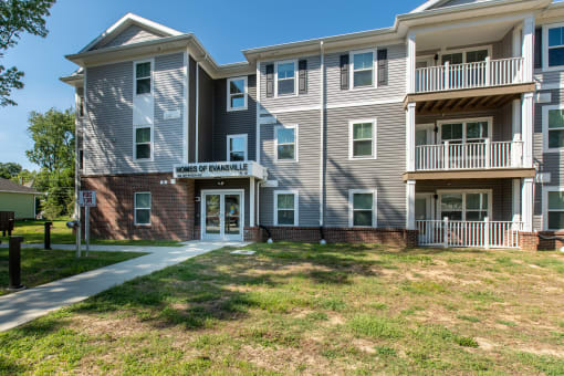 a large apartment building with a sidewalk in front of it