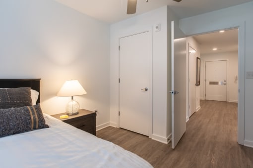 a bedroom with a large bed and a door to a hallway