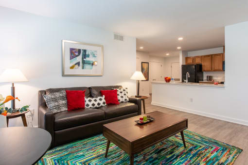 a living room with a leather couch and a coffee table