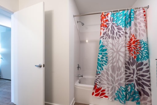 a bathroom with a shower curtain and a bath tub