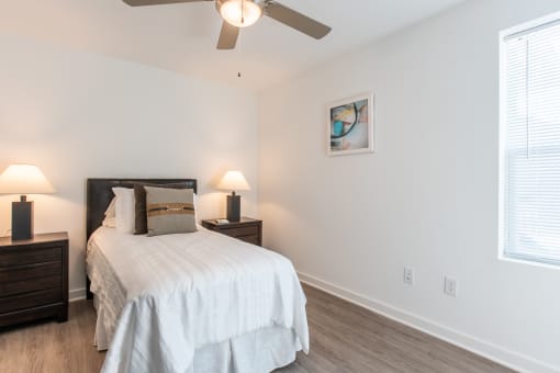 a bedroom with a bed and a ceiling fan