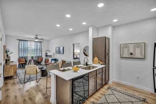 a kitchen with couches in the background