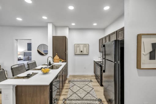 the kitchen and dining area with stainless steel appliances