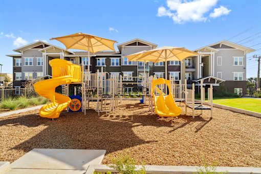 the playground with an  apartment in the back