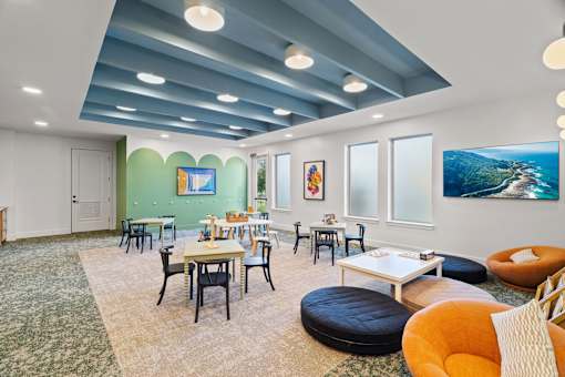 Children’s activity room featuring learning tables, creative play areas, and flexible space for educational and recreational activities.