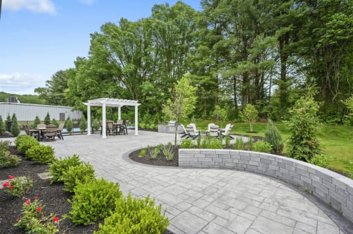 a patio with a seating area and a white gazebo