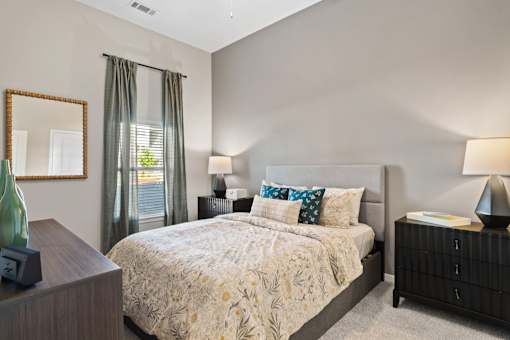 Primary bedroom featuring an en-suite bathroom, walk-in closet, and contemporary interior finishes.