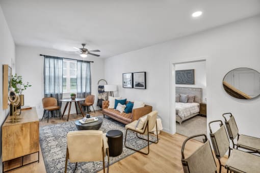 A living room with bedroom in the background