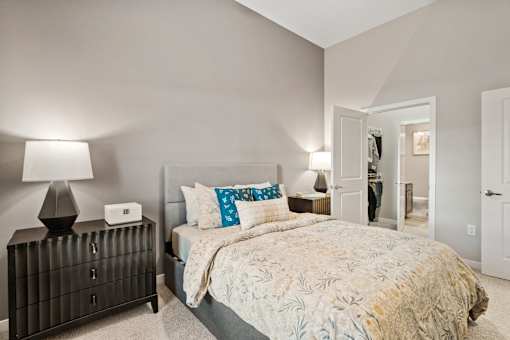 Primary bedroom featuring an en-suite bathroom, walk-in closet, and contemporary interior finishes.