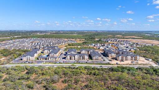 an aerial view of an apartment complex with trees