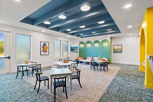 Children’s activity room featuring learning tables, creative play areas, and flexible space for educational and recreational activities.