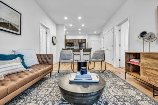 A living room with kitchen in the background