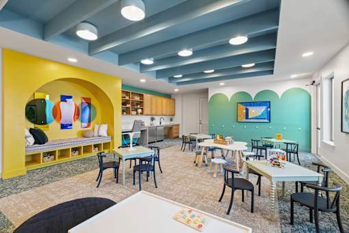 Children’s activity room featuring learning tables, creative play areas, and flexible space for educational and recreational activities.