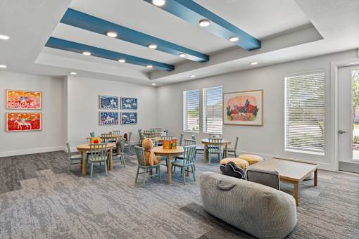 Activity room for supportive services and after-school programs at The Esther apartments with open seating and gathering space.