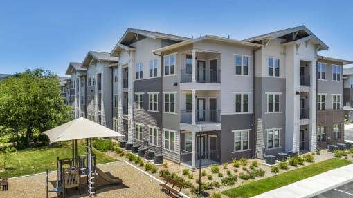 apartment buildings with a playground in front of them