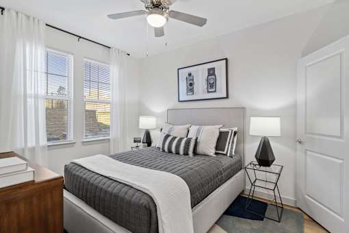 a bedroom with a bed and a ceiling fan
