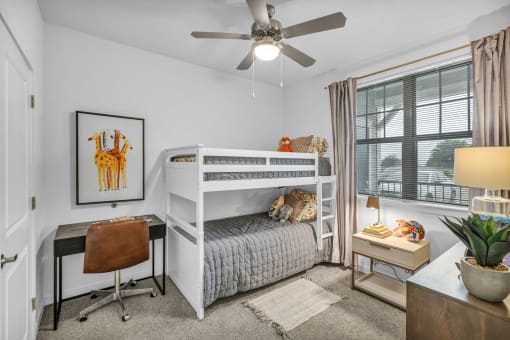 a bedroom with a bunk bed and a ceiling fan