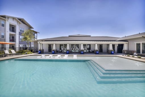 a pool with lounge chairs