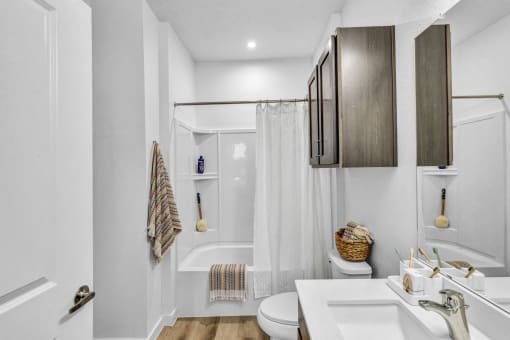 a bathroom with a shower and a sink and a toilet