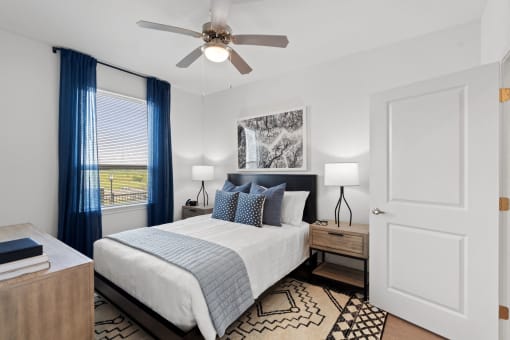 a bedroom with a bed and a ceiling fan