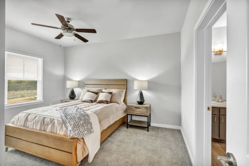 a bedroom with a bed and a ceiling fan