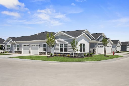 a house with a driveway and lawn in front of it