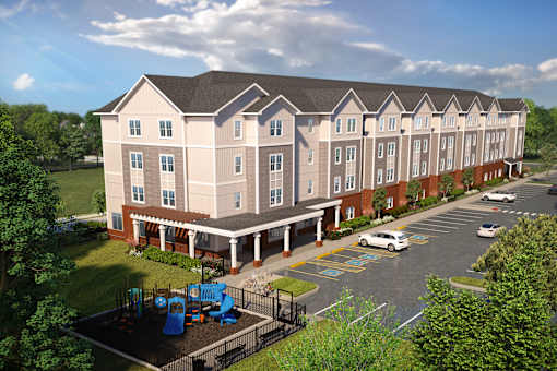 An aerial view of the Davis 2 Contemporary residential community featuring a multi-story building, organized parking, and a dedicated outdoor play area.