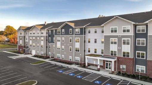 an aerial view of an apartment building in a parking lot