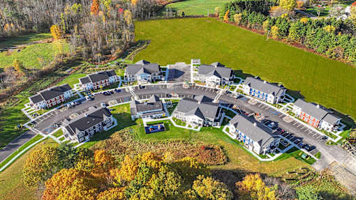 A large building complex surrounded by a green field.