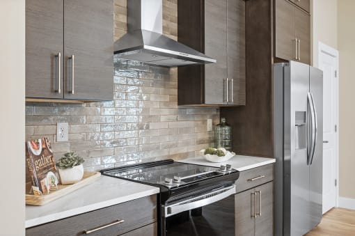 a kitchen with a stove and a refrigerator