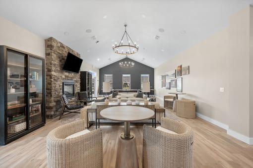 a living room with a table and chairs and a fireplace