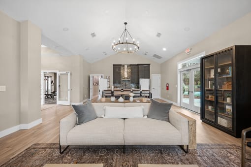 a living room with a couch in front of a dining room