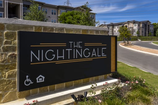 a sign for the nightingale apartments