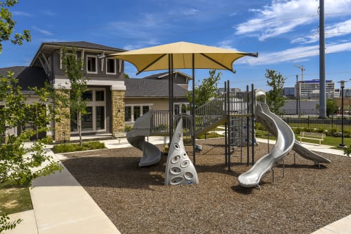 a playground with slides and umbrellas