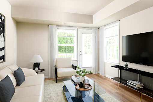 A living room with a white couch, a black television, and a glass coffee table.