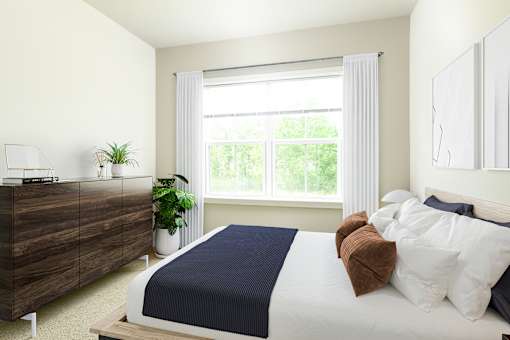 A bedroom with a bed, nightstand, and window.
