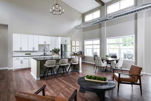 A modern kitchen with a dining table and chairs.