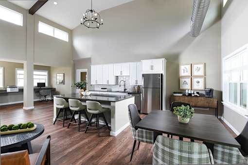 A modern kitchen with a dining table and chairs.