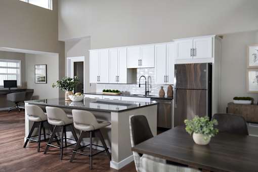 A modern kitchen with a dining table and chairs.