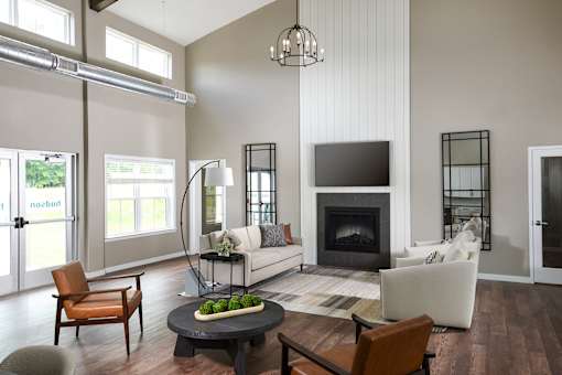 A modern living room with a fireplace and a flat screen TV.