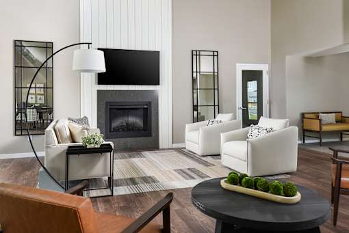 A modern room with a fireplace and a coffee table.
